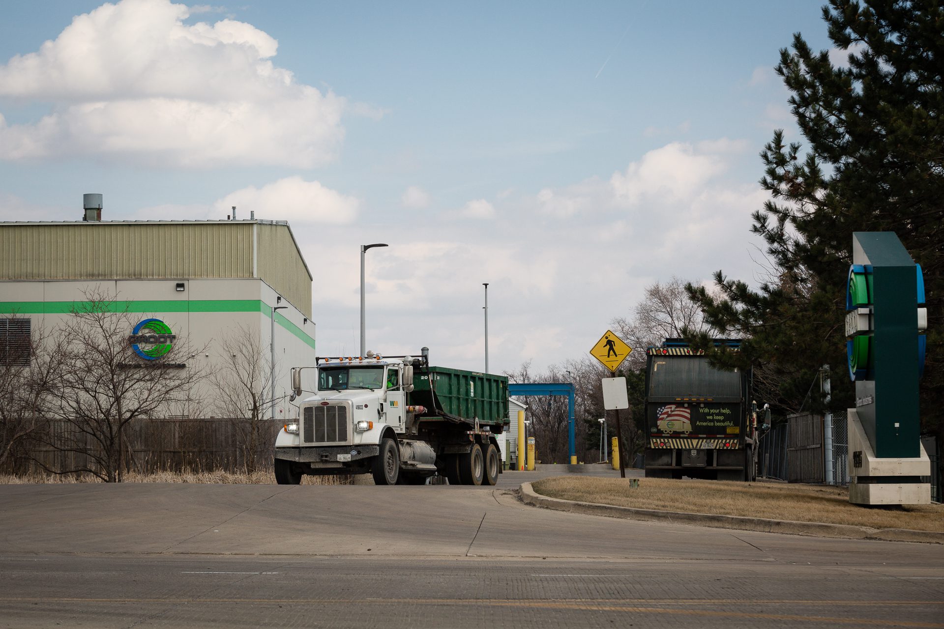 A Groot garbage trucks pulls out of the waste transfer facility as another pulls in