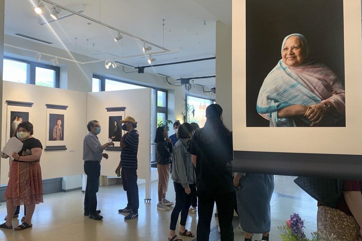 people attend a photo gallery exhibit