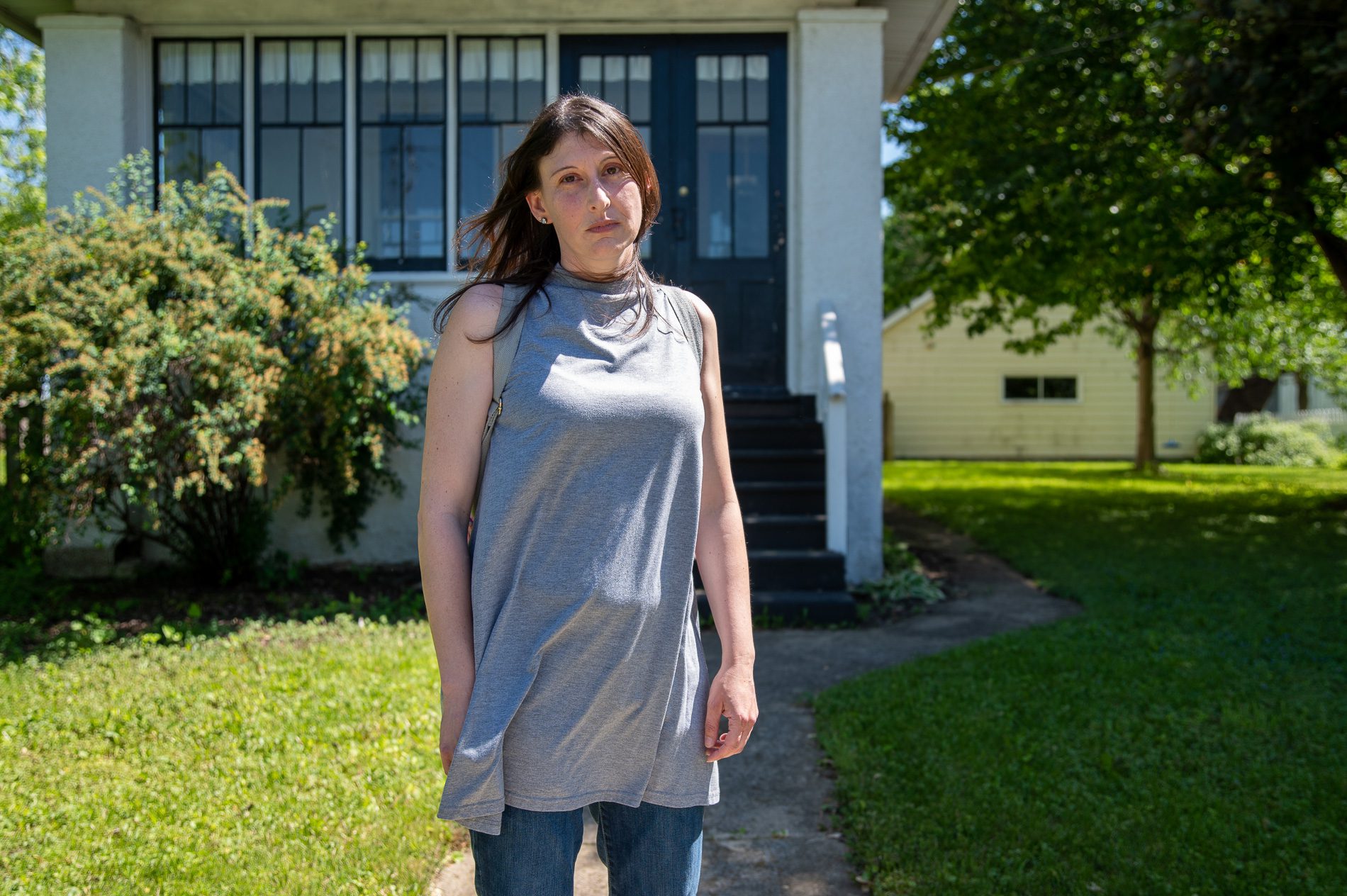 Erika Bartlett outside in front of her childhood home